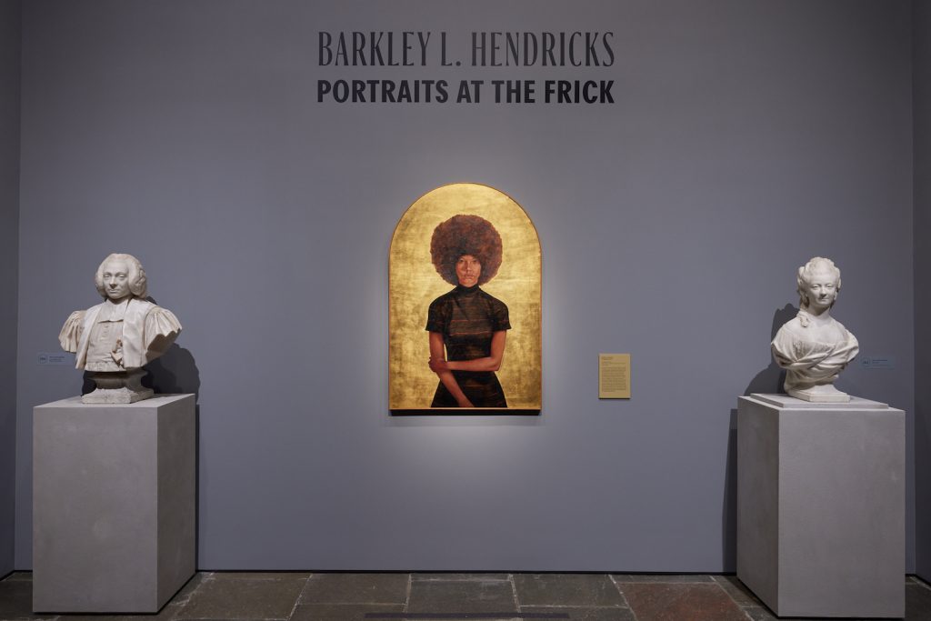 Barkley Hendricks, Lawdy Mama (1969) flanked at the exhibition's entrance by Frick Collection's works by Jean-Antoine Houdon. Photo by George Koelle. ©Barkley L. Hendricks. Lawdy Mama. Studio Museum in Harlem, gift of Stuart Liebman in memory of Joseph B. Liebman.